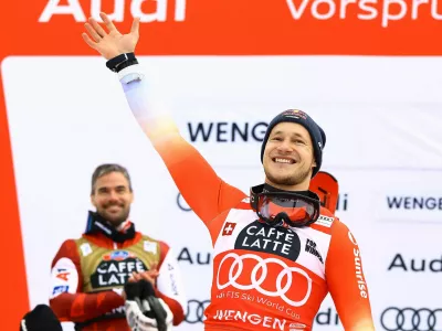 Alpine Skiing - FIS Alpine Ski World Cup - Men's Downhill - Wengen, Switzerland - January 17, 2026 Switzerland's Marco Odermatt celebrates on the podium after winning the men's downhill with second placed Austria's Vincent Kriechmayr REUTERS/Lisi Niesner