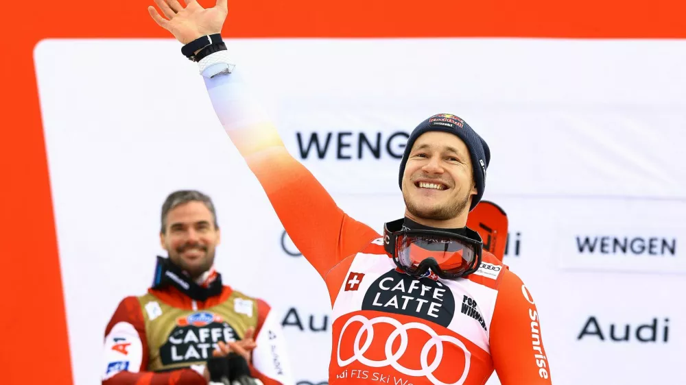 Alpine Skiing - FIS Alpine Ski World Cup - Men's Downhill - Wengen, Switzerland - January 17, 2026 Switzerland's Marco Odermatt celebrates on the podium after winning the men's downhill with second placed Austria's Vincent Kriechmayr REUTERS/Lisi Niesner