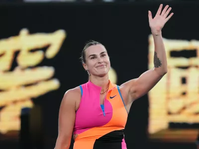 Aryna Sabalenka of Belarus waves after defeating Tiantsoa Rakotomanga Rajaonah of France in their first round match at the Australian Open tennis championship in Melbourne, Australia, Sunday, Jan. 18, 2026. (AP Photo/Dita Alangkara)