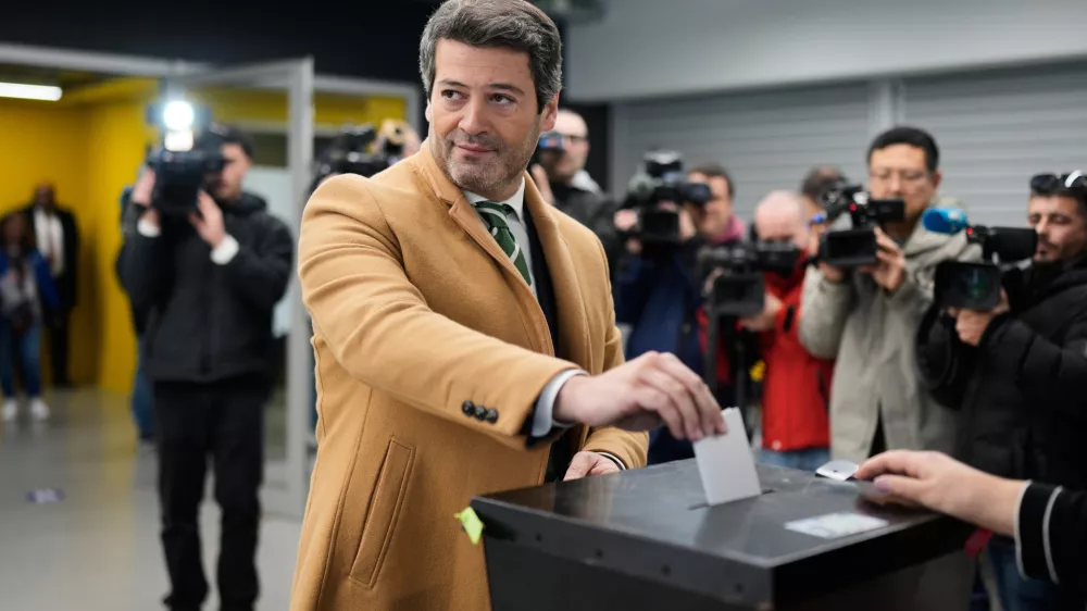 Presidential candidate Andre Ventura, of the populist Chega party, poses for the cameras when casting his ballot in Portugal's presidential election at a polling station in Lisbon, Sunday, Jan. 18, 2026. (AP Photo/Armando Franca)