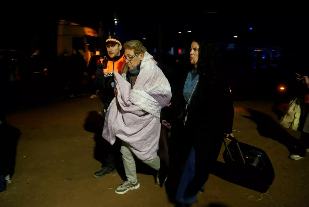 A person affected by a deadly train derailment is transferred for treatment to the Caseta Municipal in the town of Adamuz, after a high-speed train derailed and collided with another oncoming train near Cordoba, Spain, January 18, 2026. REUTERS/Alex Gallegos   TPX IMAGES OF THE DAY