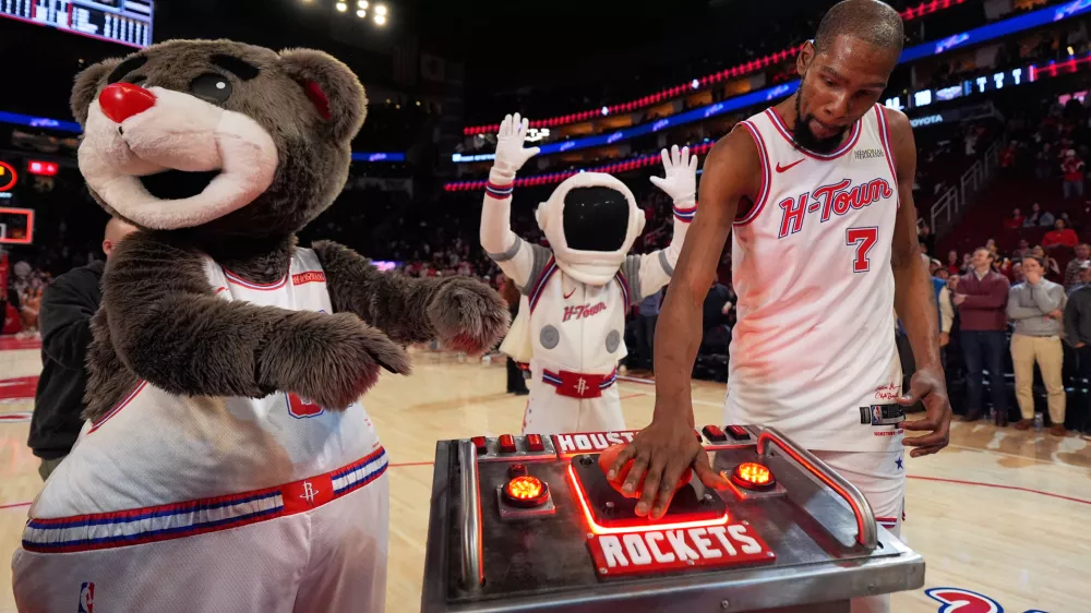 Houston Rockets forward Kevin Durant (7) presses a launch button after surpassing Dirk Nowitzki to become the NBA's sixth all-time leading scorer in an NBA basketball game against the New Orleans Pelicans in Houston, Sunday, Jan. 18, 2026. (AP Photo/Ashley Landis)