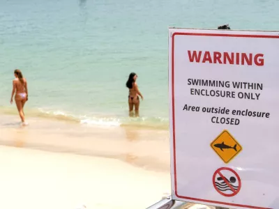 A warning sign is in place for swimmers following the recent shark attack at Sydney Harbour, Australia, January 19, 2026. REUTERS/Jeremy Piper