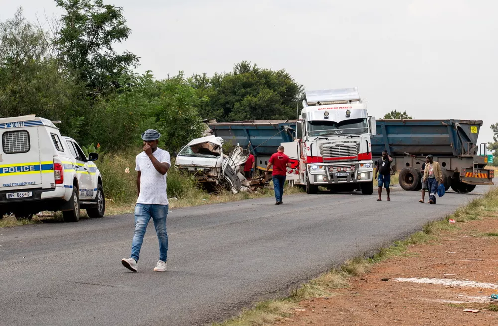 A man walks near the scene of a fatal crash of 13 schoolchildren who perished ​when their minibus collided with a truck, in Johannesburg, South Africa, January 19, 2026. REUTERS/Shiraaz Mohamed