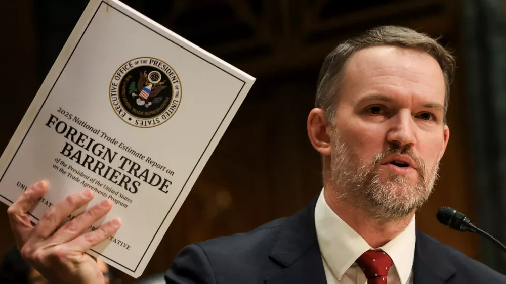 U.S. Trade Representative Jamieson Greer holds a copy of "Foreign Trade Barriers" as he testifies before a Senate Finance Committee hearing on U.S. President Donald Trump's trade policy, on Capitol Hill in Washington, D.C., U.S., April 8, 2025. REUTERS/Kevin Mohatt