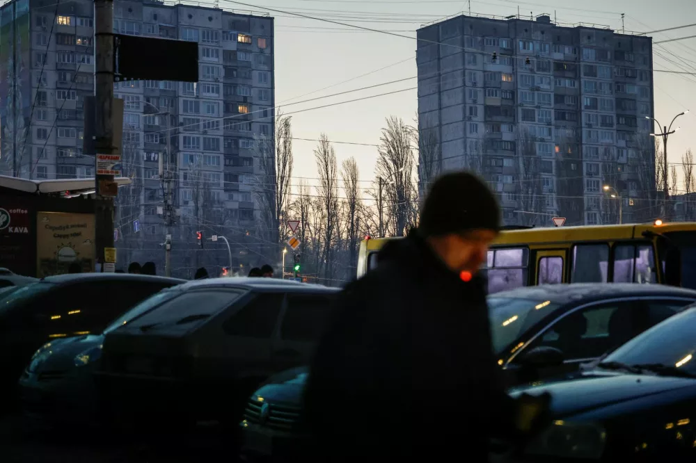 A man smokes a cigarette as he walks through a residential area on a frosty winter day, soon after an air alert ended following a Russian missile and drone attack, during a power blackout after critical civil infrastructure was hit recently, amid Russia's attack on Ukraine, in Kyiv, Ukraine January 20, 2026. REUTERS/Alina Smutko   TPX IMAGES OF THE DAY