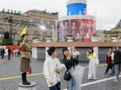 Chinese tourists take a selfie at Red Square during an installation dedicated to the 80th anniversary of the Victory Parade, in Moscow. June 22, 2025. China has become trendy for Russians who once worshiped everything Western.,Image: 1016509926, License: Rights-managed, Restrictions:, Model Release: no