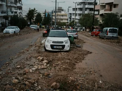 Mud and stones cover a street after flooding caused by heavy rain in the Glyfada district of Athens, Thursday, Jan. 22, 2026. (AP Photo/Thanassis Stavrakis)
