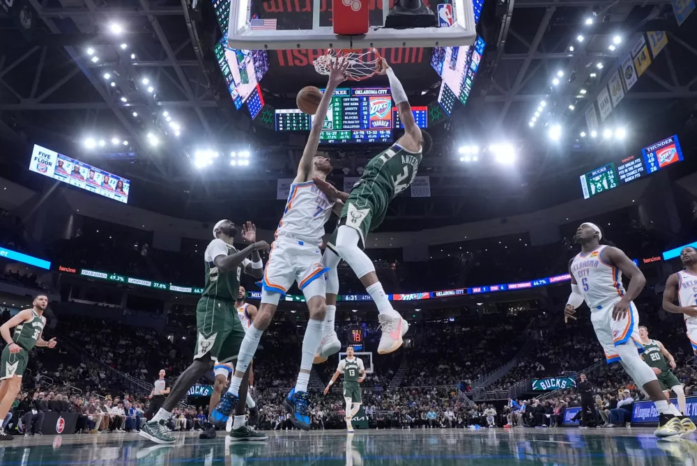 Milwaukee Bucks' Giannis Antetokounmpo dunks over Oklahoma City Thunder's Chet Holmgren during the second half of an NBA basketball game Wednesday, Jan. 21, 2026, in Milwaukee. (AP Photo/Morry Gash)
