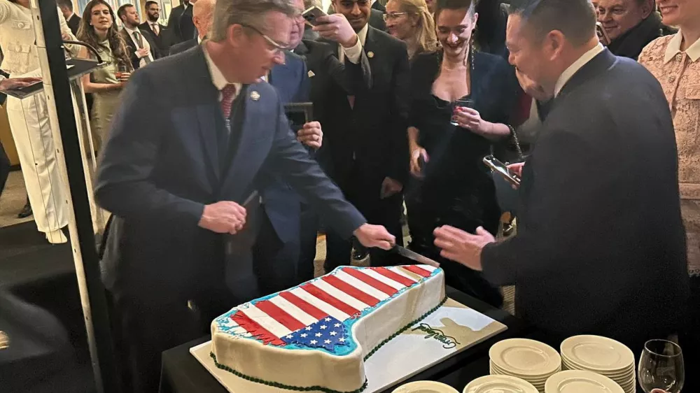 A Greenland-shaped cake decorated with the U.S. flag is being sliced at the Republicans for National Renewal anniversary event at the Kennedy Center in Washington, D.C., U.S., January 20, 2026. Republicans for National Renewal/via REUTERS THIS IMAGE HAS BEEN SUPPLIED BY A THIRD PARTY. MANDATORY CREDIT. NO RESALES. NO ARCHIVES. MANDATORY CREDIT. Verification line: Reuters was able to verify the location with the floor tiles, the windows and interior design that matched the file imagery from the interior of the Kennedy Center. The date was confirmed by the Republicans for National Renewal and verified by the corroborating visuals from the event.