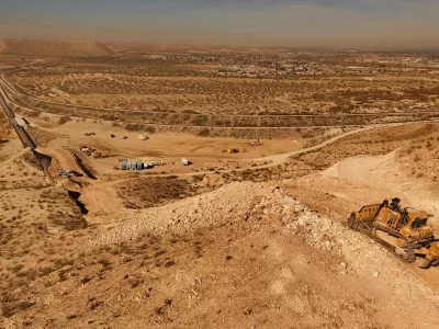 An aerial view shows machinery during the construction of a new section of the border wall at Monte Cristo Rey in Sunland Park, New Mexico, on the U.S.-Mexico border, part of the "Smart Wall" project promoted by U.S. President Donald Trump's administration to combat irregular migration from Mexico into the United States, seen from Ciudad Juarez, Mexico, January 21, 2026. REUTERS/Jose Luis Gonzalez