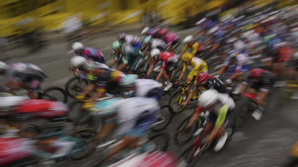 The pack with Slovenia's Tadej Pogacar, wearing the overall leader's yellow jersey, rides during the twenty-first stage of the Tour de France cycling race over 132.3 kilometers (82.1 miles) with start in Mantes-la-Ville and finish on the Champs-Elysees in Paris, France, Sunday, July 27, 2025. (AP Photo/Thibault Camus)