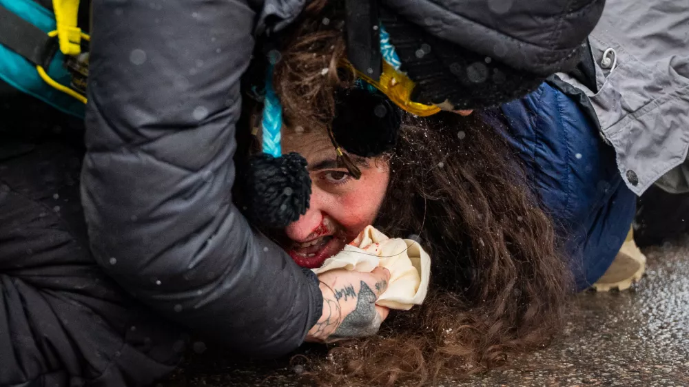 Federal agents detain a person on Wednesday, Jan. 21, 2026, in Minneapolis. (AP Photo/Angelina Katsanis)