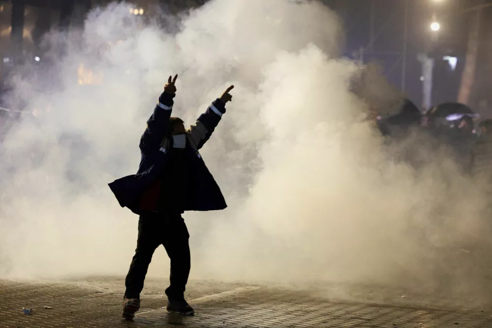 A demonstrator gestures during an anti-government protest, triggered by a corruption investigation into Deputy Prime Minister Belinda Balluku, near the Prime Minister's office in Tirana, Albania, January 24, 2026. REUTERS/Florion Goga