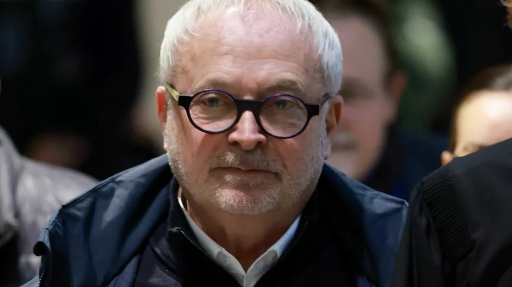 Former French Senator Joel Guerriau arrives with his lawyer Henri Carpentier for a hearing in his trial for allegedly spiking member of parliament Sandrine Josso's drink with the intention of sexually assaulting her, at the courthouse in Paris, France, January 26, 2026. REUTERS/Stephanie Lecocq