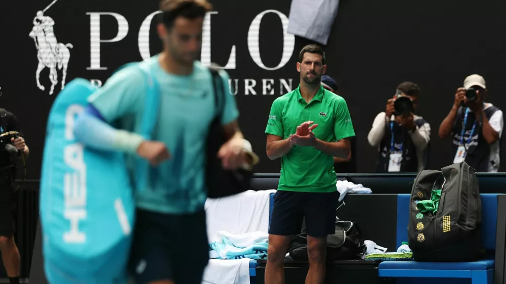 Tennis - Australian Open - Melbourne Park, Melbourne, Australia - January 28, 2026 Serbia's Novak Djokovic applauds for Italy's Lorenzo Musetti after he retires from their quarter final match REUTERS/Hollie Adams