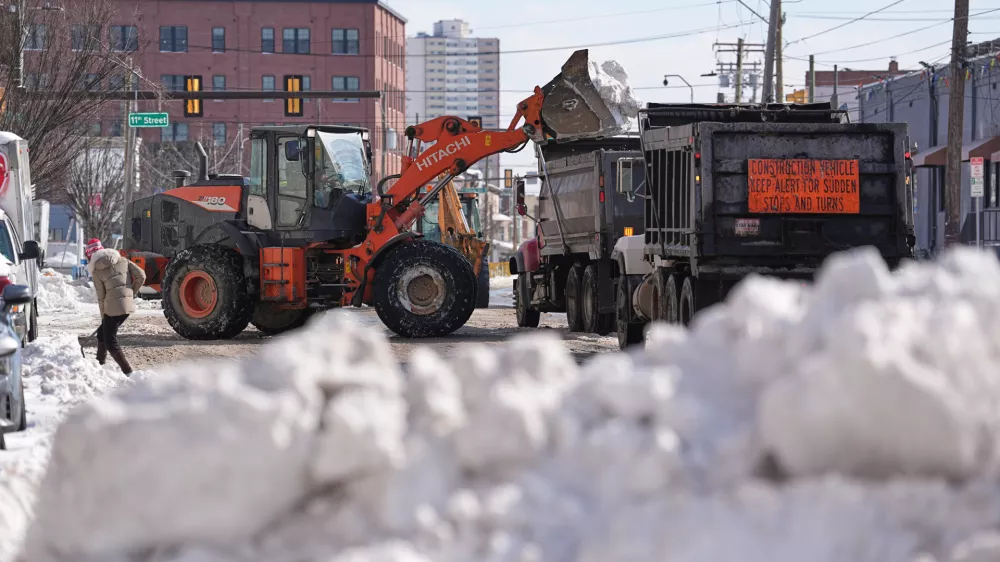 Snow is removed in the aftermath of a winter storm in Philadelphia, Monday, Jan. 26, 2026. (AP Photo/Matt Rourke)