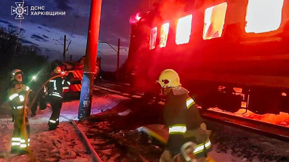 In this photo provided by the Ukrainian Emergency Service, firefighters put out the fire after Russian drones hit a passenger train in the Kharkiv region, Ukraine, Tuesday, Jan. 27, 2026. (Ukrainian Emergency Service via AP)