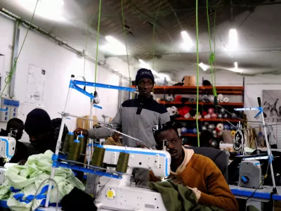 FILE PHOTO: Former street vendor and tailor immigrants sew clothes to sell the collections in a Top Manta shop in Barcelona's Raval district, Spain December 5, 2025. "Top Manta" is the name given to street vendors in Spain, where mantas (blankets) are used to display goods. REUTERS/Nacho Doce/File Photo