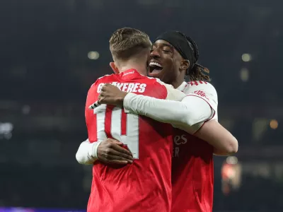 Arsenal's Viktor Gyoekeres, left, celebrates after scoring his side's opening goal with his teammate Noni Madueke during the Champions League opening phase soccer match between Arsenal and Kairat Almaty in London, Wednesday, Jan. 28, 2026. (AP Photo/Ian Walton)