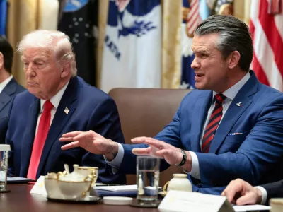 FILE PHOTO: U.S. Defense Secretary Pete Hegseth speaks next to President Donald Trump during a cabinet meeting at the White House in Washington, D.C., U.S., January 29, 2026. REUTERS/Evelyn Hockstein/File Photo