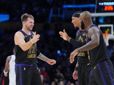 Los Angeles Lakers guard Luka Doncic, from left, center Jaxson Hayes and forward LeBron James (23) react to a play during the second half of an NBA basketball game against the Utah Jazz Tuesday, Nov. 18, 2025, in Los Angeles. (AP Photo/Jae C. Hong)