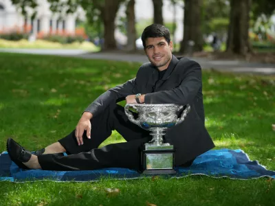 Carlos Alcaraz of Spain poses with the Norman Brookes Challenge Cup the morning after defeating Novak Djokovic of Serbia in the men's singles final at the Australian Open tennis championship, in Melbourne, Australia, Monday, Feb. 2, 2026. (AP Photo/Dita Alangkara)