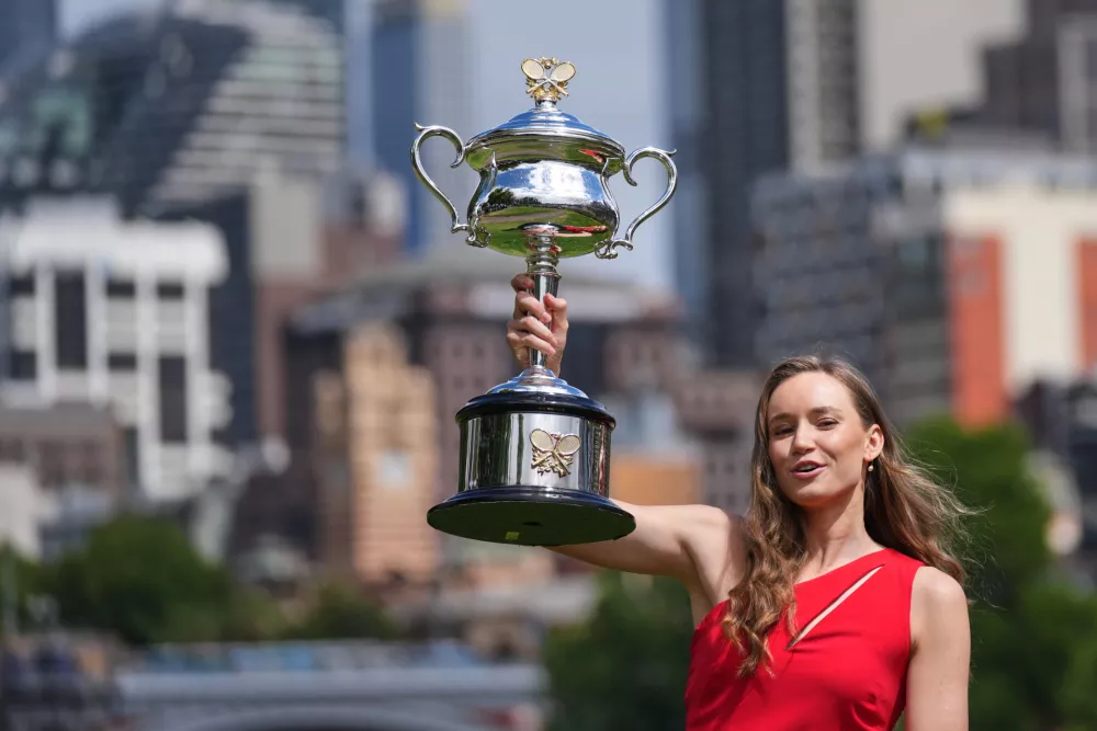 Elena Rybakina of Kazakhstan poses with Daphne Akhurst Memorial Cup on the banks of the Yarra River the morning after defeating Aryna Sabalenka of Belarus in the women's singles final at the Australian Open tennis championship in Melbourne, Australia, Sunday, Feb. 1, 2026. (AP Photo/Dita Alangkara)