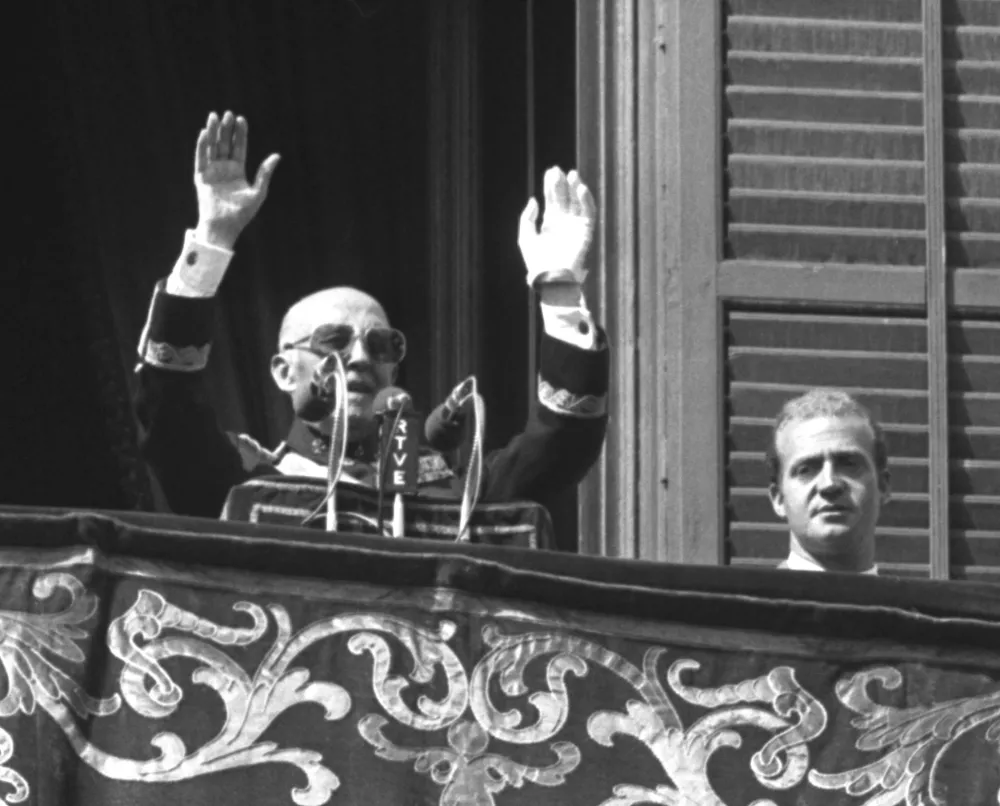 FILE PHOTO: Former Spanish dictator General Francisco Franco speaks from the balcony of Madrid's Royal Palace next to the then Prince Juan Carlos of Spain in this undated file photo. REUTERS/File Photo