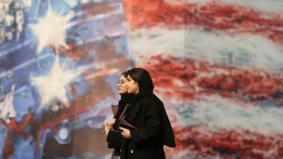 People walk past an anti-U.S. billboard in Tehran, Iran, January 26, 2026. Majid Asgaripour/WANA (West Asia News Agency) via REUTERS ATTENTION EDITORS - THIS PICTURE WAS PROVIDED BY A THIRD PARTY   TPX IMAGES OF THE DAY