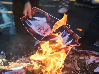 Protesters burn pictures of Iranian Supreme Leader Ayatollah Ali as they march in support of regime change in Iran during a protest in Toronto, on Sunday, Feb. 1, 2026. (Sammy Kogan/The Canadian Press via AP)