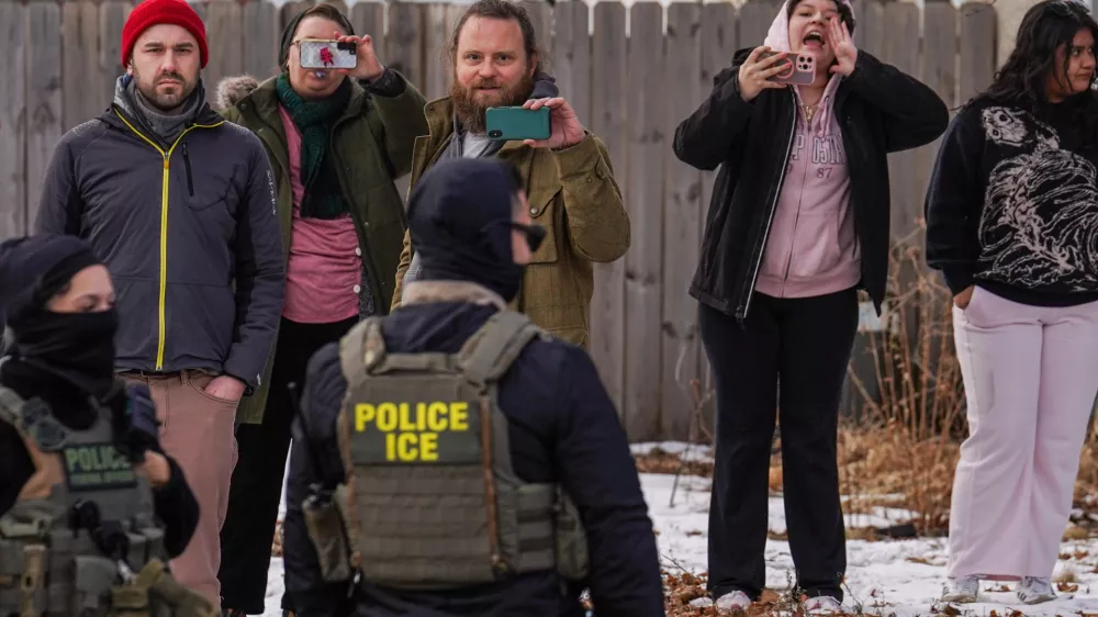 Observers film while federal agents conduct immigration enforcement operations, on Thursday, Feb. 5, 2026, in Minneapolis. (AP Photo/Ryan Murphy)