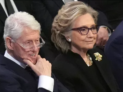 FILE - Former President Bill Clinton and former Secretary of State Hillary Clinton listen during the state funeral for former President Jimmy Carter at Washington National Cathedral in Washington, Jan. 9, 2025. (AP Photo/Jacquelyn Martin, File)