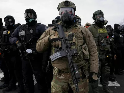 Members of U.S. Customs and Border Protection (CBP) and other law enforcement officials stand guard, in front of the Bishop Henry Whipple Federal Building, during a protest more than a week after an ICE agent fatally shot Renee Nicole Good, in Minneapolis, Minnesota, U.S., January 17, 2026. REUTERS/Seth Herald TPX IMAGES OF THE DAY