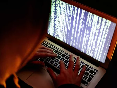 A hacker in action behind a computer. A hacker (sometimes also called a squatter or cracker) is a person who penetrates a computer network by evading security. There are hackers with criminal intentions (black hats); for many, however, it is a sport to crack secure networks and where possible to report ethically. Netherlands on March 14, 2022. Photo by Robin Utrecht/ABACAPRESS.COMNo Use Netherlands. No Use Germany.