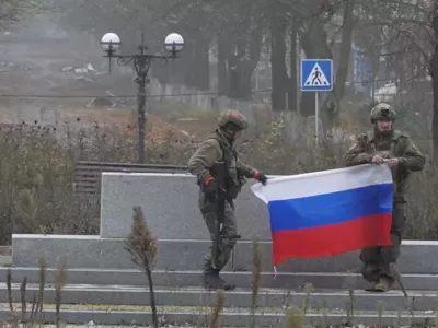 Soldiers hold a Russian flag in Pokrovsk, Donetsk Region, Ukraine, in this screengrab from video released December 1, 2025. Russian Defence Ministry/Handout via REUTERS  THIS IMAGE HAS BEEN SUPPLIED BY A THIRD PARTY. MUST NOT OBSCURE LOGO. VERIFICATION: - Reuters was able to confirm the location of the video as Pokrovsk from the buildings, the road layout and trees which matched file and satellite imagery of the area. - The date when the video was recorded could not be verified independently.