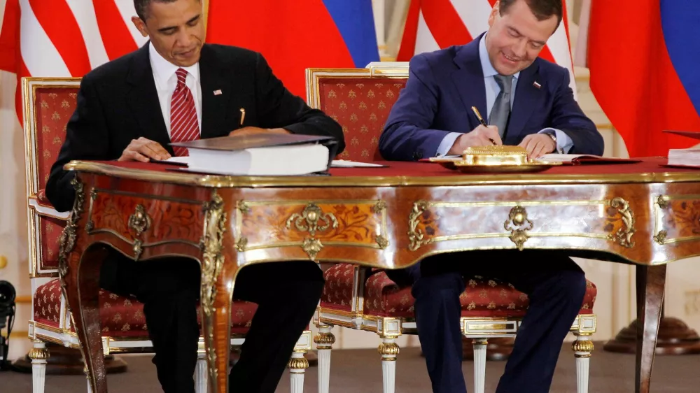 FILE PHOTO: Barack Obama (L) and Dmitry Medvedev, who were then the U.S. and Russian presidents, sign the new Strategic Arms Reduction Treaty (START II) at Prague Castle in Prague April 8, 2010.   REUTERS/Jason Reed/File Photo