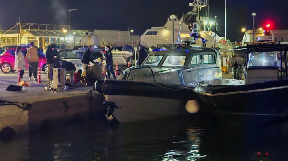 Greek coast guard officers carry out rescue operations at a port on the eastern Aegean island of Chios, Greece, late Tuesday, Feb. 3, 2026, after a collision between a migrant speedboat and a coast guard patrol vessel killed multiple people, authorities said. (Pantelis Fykaris/Politischios.gr via AP)