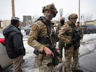 Federal agents stand next to a man they approached during immigration enforcement action the day after the fatal shooting of Renee Nicole Good by a U.S. Immigration and Customs Enforcement (ICE) agent, in Minneapolis, Minnesota, U.S., January 8, 2026. REUTERS/Tim Evans