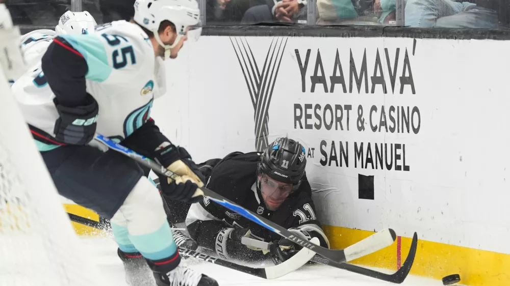 Los Angeles Kings center Anze Kopitar (11) falls to the ice while chasing the puck during the second period of an NHL hockey game against the Seattle Kraken Wednesday, Feb. 4, 2026, in Los Angeles. (AP Photo/Jae C. Hong)