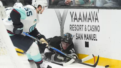 Los Angeles Kings center Anze Kopitar (11) falls to the ice while chasing the puck during the second period of an NHL hockey game against the Seattle Kraken Wednesday, Feb. 4, 2026, in Los Angeles. (AP Photo/Jae C. Hong)
