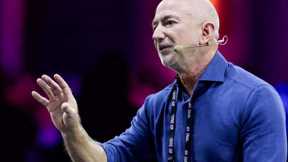 Amazon founder Jeff Bezos gestures as he speaks at the main panel of Italian Tech Week 2025 in Turin, Italy October 3, 2025. REUTERS/Remo Casilli