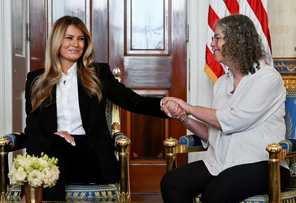 U.S. first lady Melania Trump holds hands with freed American-Israeli Aviva Siegel, who was abducted along with her partner Keith by Hamas on October 7, 2023, at the White House in Washington, D.C., U.S., February 4, 2026. REUTERS/Annabelle Gordon   TPX IMAGES OF THE DAY