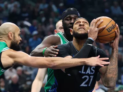 Feb 3, 2026; Dallas, Texas, USA; Dallas Mavericks forward Daniel Gafford (21) looks to score as Boston Celtics guard Derrick White (9) defends during the first quarter at American Airlines Center. Mandatory Credit: Kevin Jairaj-Imagn Images