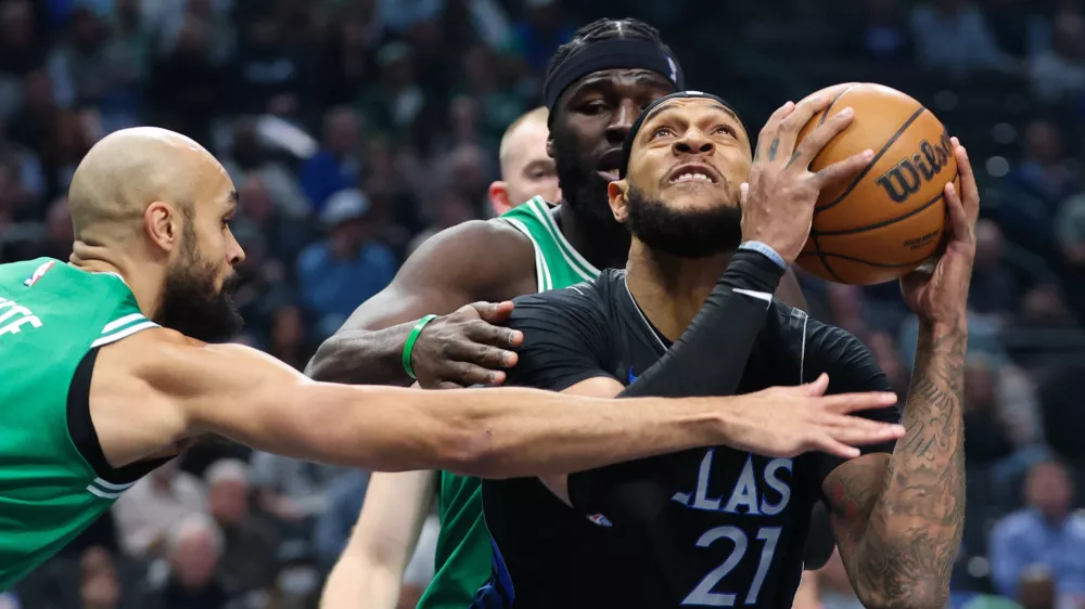 Feb 3, 2026; Dallas, Texas, USA; Dallas Mavericks forward Daniel Gafford (21) looks to score as Boston Celtics guard Derrick White (9) defends during the first quarter at American Airlines Center. Mandatory Credit: Kevin Jairaj-Imagn Images