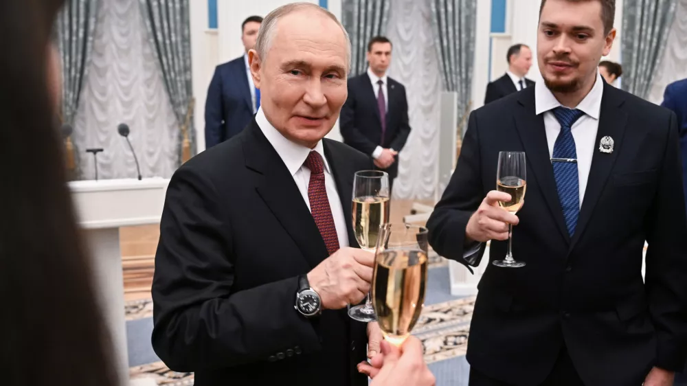 Russian President Vladimir Putin, center, toasts with participants of a ceremony to present the 2025 Presidential Prizes in Science and Innovation for Young Scientists at the Kremlin, in Moscow, Thursday, Feb. 5, 2026. (Kristina Solovyova/Sputnik, Kremlin Pool Photo via AP)