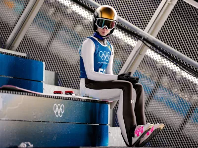 Nika Prevc, of Slovenia, waits her turn to jump during a ski jumping, women's normal hill, training session, at the 2026 Winter Olympics, in Predazzo, Italy, Thursday, Feb. 5, 2026. (AP Photo/Matthias Schrader)