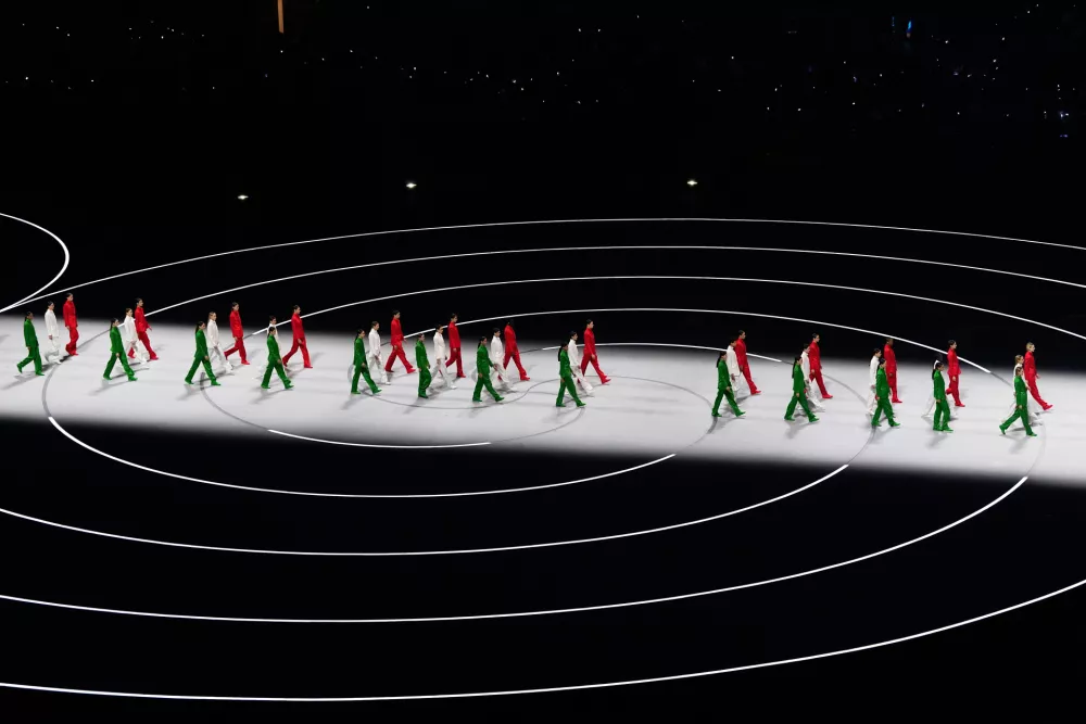 Artists wearing Italian colors perform during the Olympic opening ceremony at the 2026 Winter Olympics, in Milan, Italy, Friday, Feb. 6, 2026. (AP Photo/Petr David Josek)