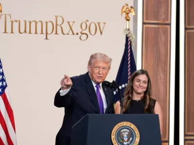 President Donald Trump speaks about TrumpRx in the South Court Auditorium in the Old Eisenhower Executive Office Building on the White House campus, Thursday, Feb. 5, 2026, in Washington, as Catherine Rayner listens. (AP Photo/Alex Brandon)