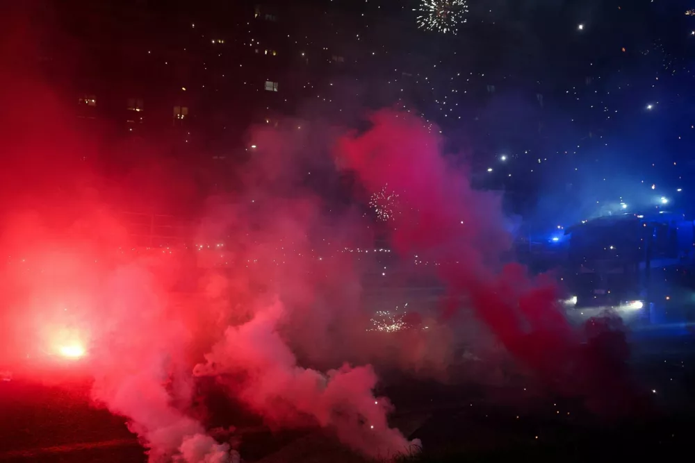 Fireworks explode, as demonstrators use them against police officers while trying to block a road leading to the Santa Giulia Arena, on the day of a protest against the environmental, economic and social impact of the Milano-Cortina 2026 Winter Olympics, in Milan, Italy, February 7, 2026. REUTERS/Claudia Greco    TPX IMAGES OF THE DAY